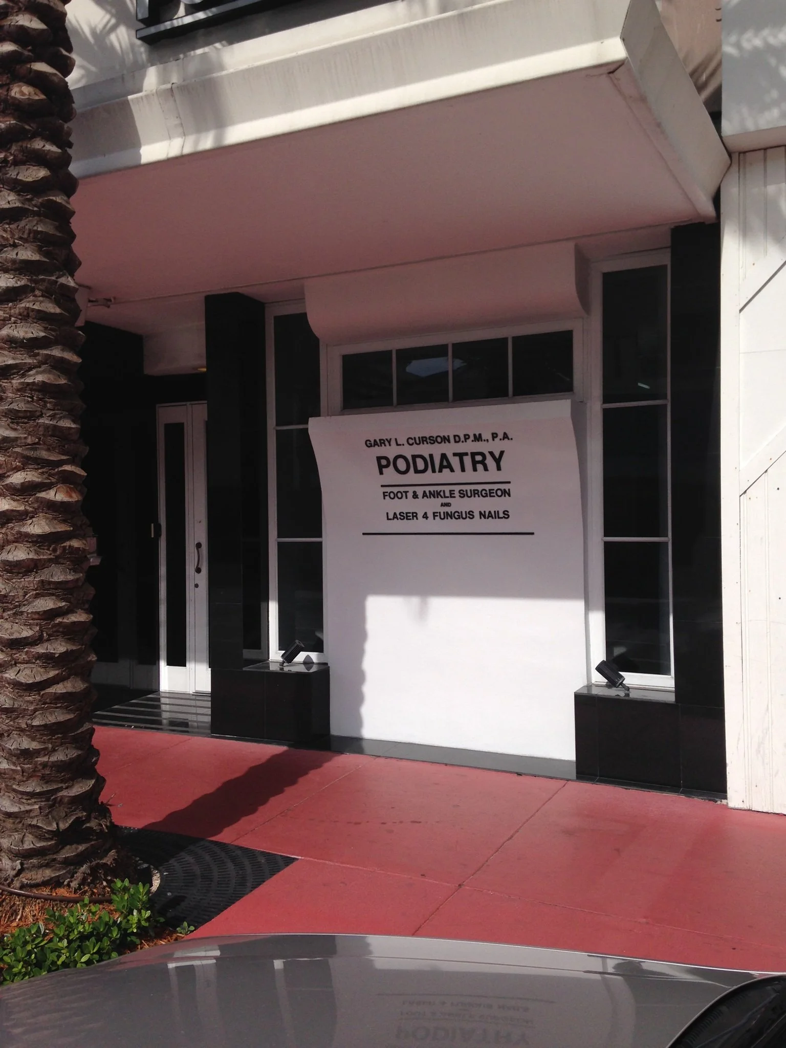 Dr. Gary L. Curson D.P.M., P.A. Podiatry storefront in Miami Beach with signage for foot and ankle surgeon and laser fungus nail treatment